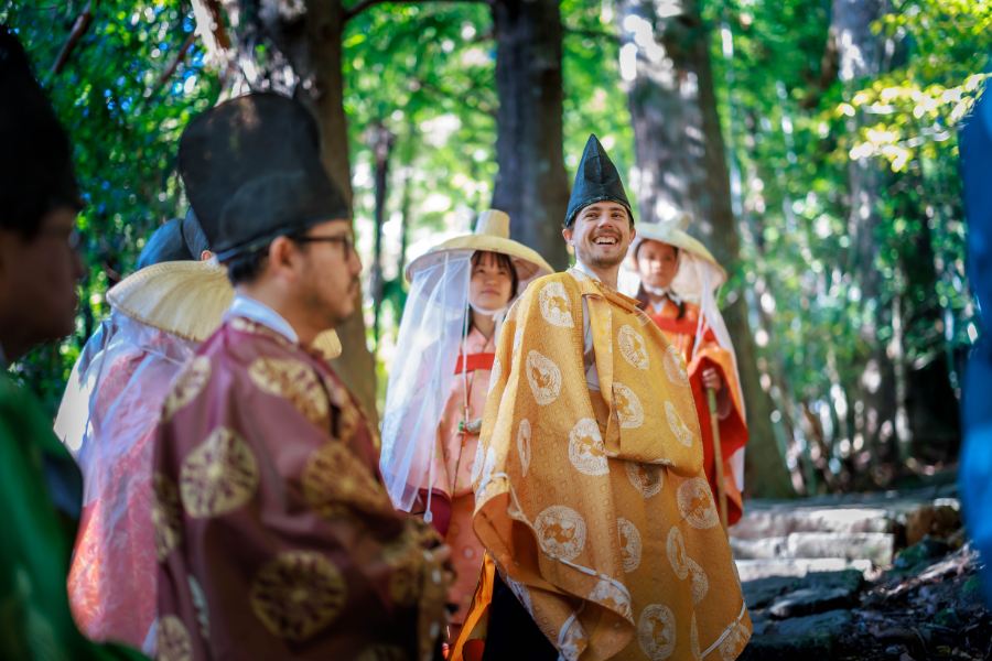 Pilgrims wearing Heian kimono walking along the historic Kumano Kodo trail in Japan.